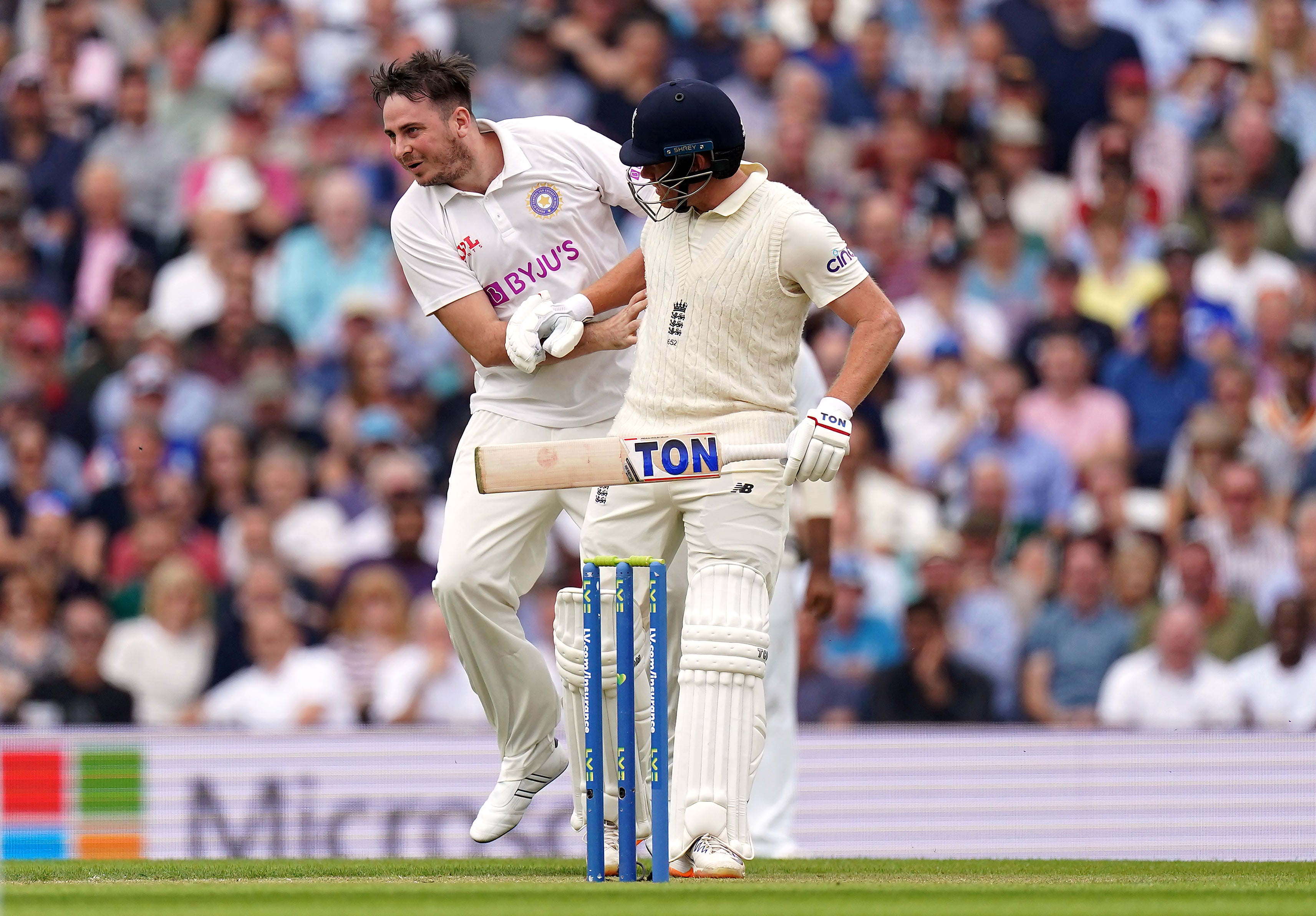 Pitch invader Daniel Jarvis, left, collides with England batsman Jonny Bairstow (Adam Davy/PA)