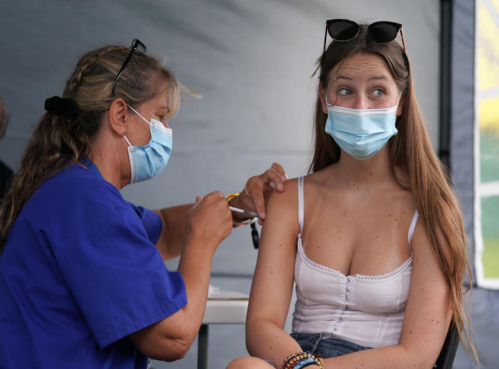 <p>Jam Budden, 16, receives a jab at a walk-in Covid-19 clinic at Reading Festival</p>