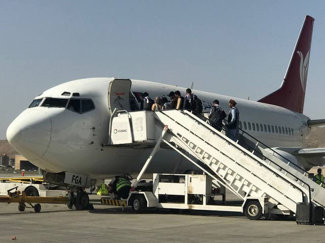 <p>Afghans and others board a flight at Kabul’s Hamid Karzai International Airport on Saturday after domestic flights resumed at the facility. </p>
