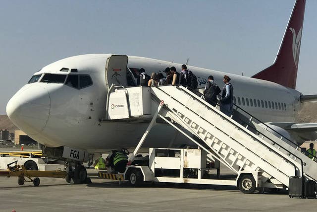 <p>Afghans and others board a flight at Kabul’s Hamid Karzai International Airport on Saturday after domestic flights resumed at the facility. </p>