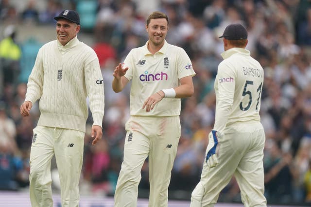 Ollie Robinson (centre) celebrates taking the wicket of India’s Rohit Sharma (Adam Davy/PA)