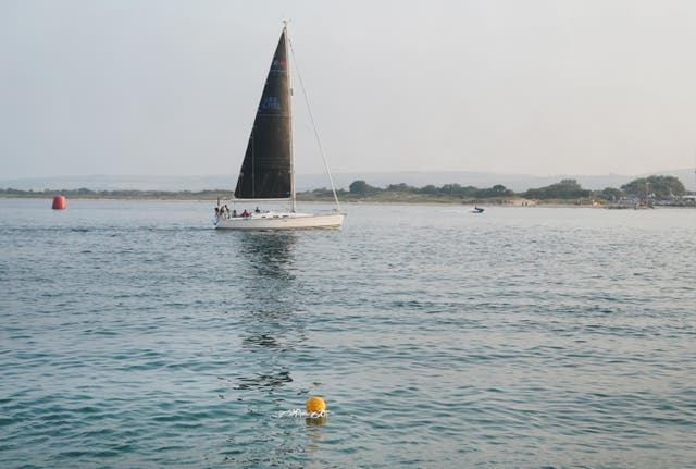 <p>A buoy marks the spot where a wing-walking plane crashed into Poole Harbour </p>