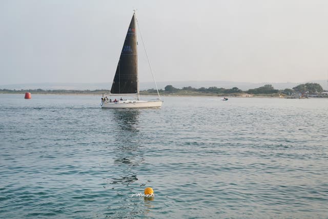 <p>A buoy marks the spot where a wing-walking plane crashed into Poole Harbour </p>