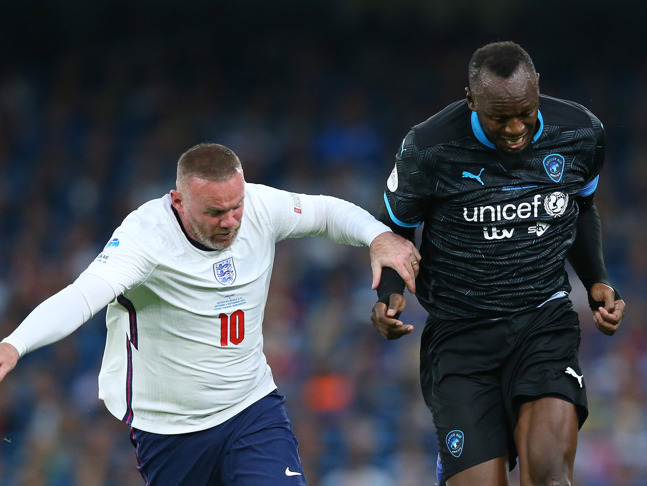 Bolt battling against Wayne Rooney at Soccer Aid