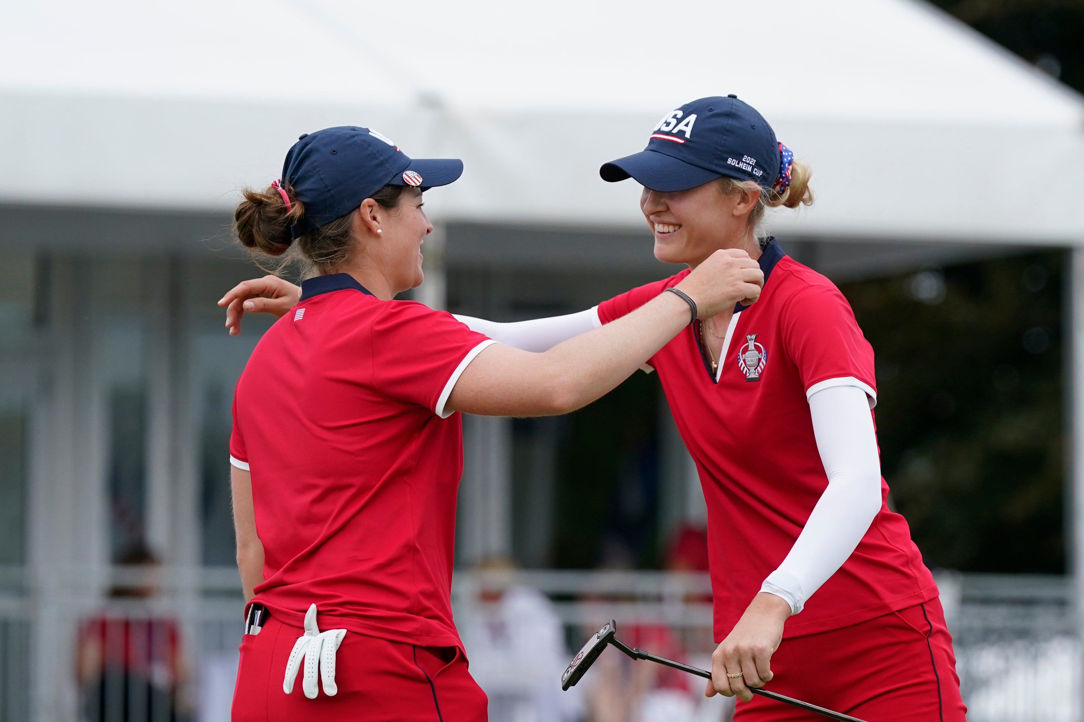 Ally Ewing, left, and Nelly Korda celebrate their win on the 18th green (Carlos Osorio/AP)