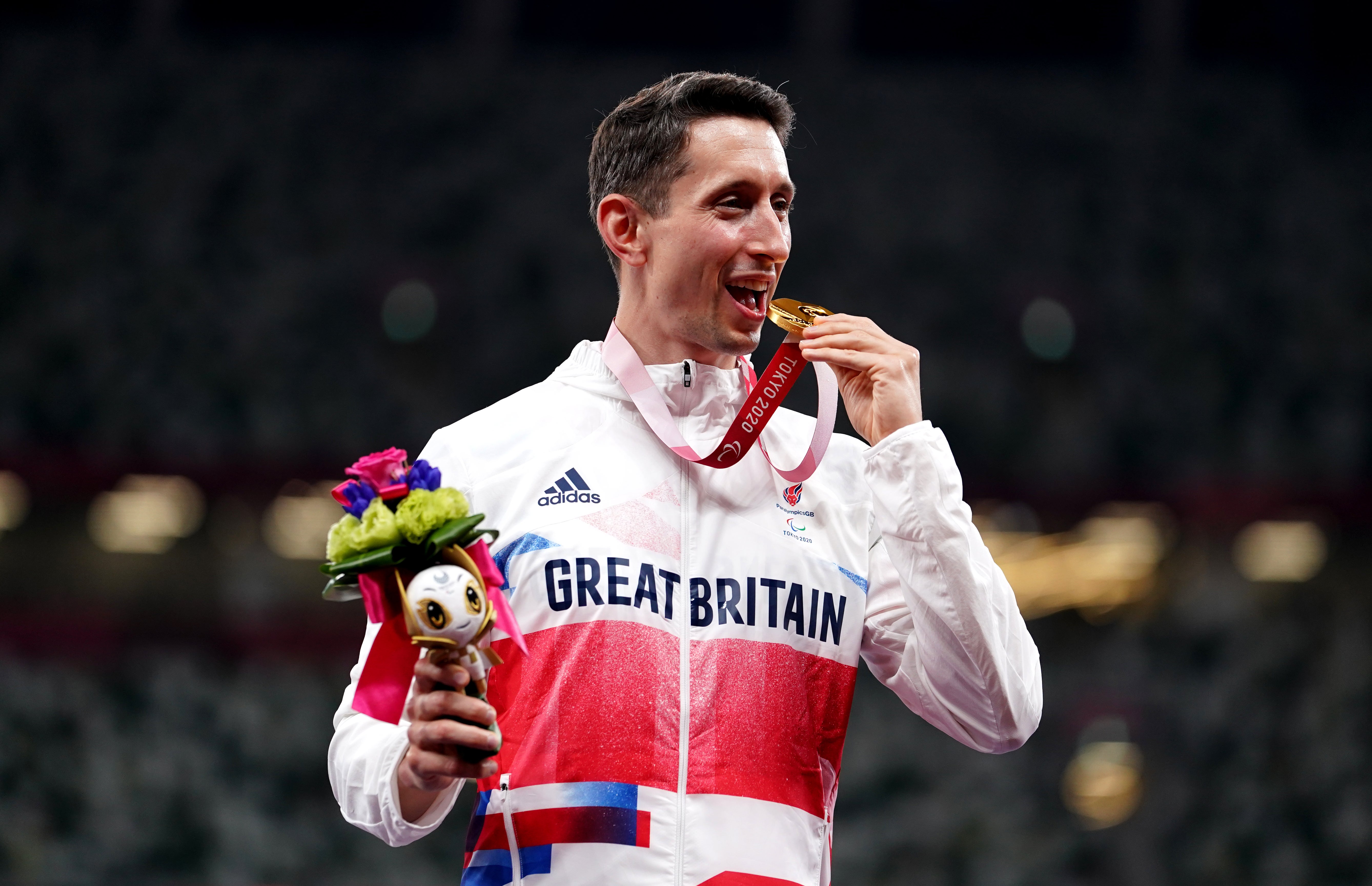 Jonathan Broom-Edwards celebrates with his gold medal after winning the men’s high jump – T64 (John Walton/PA)