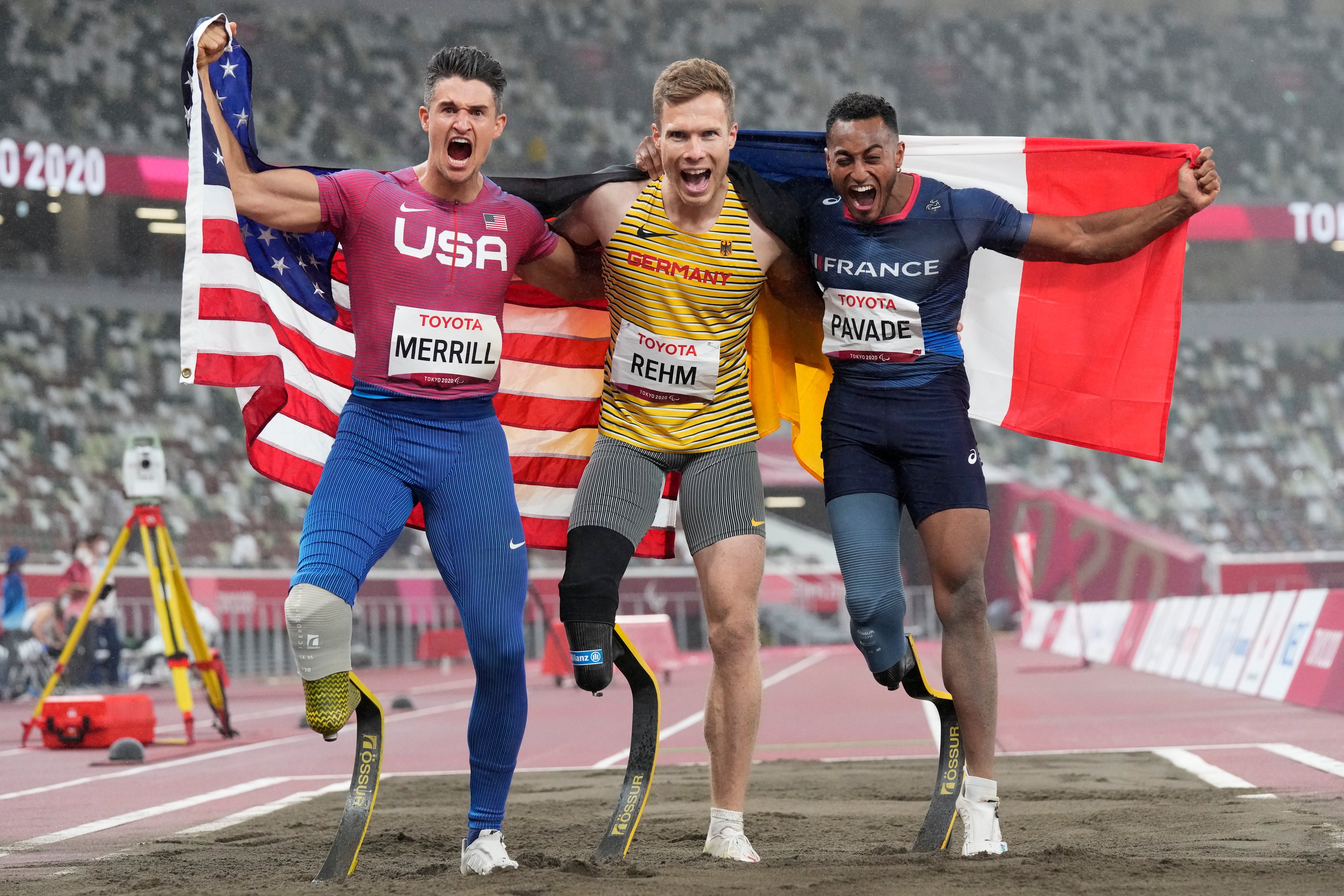 Germany’s Markus Rehm (centre) claimed gold in the men’s long jump T64, pictured here with silver winner Dimitri Pavade (right) and third-placed Trenten Merrill (Eugene Hoshiko/AP)