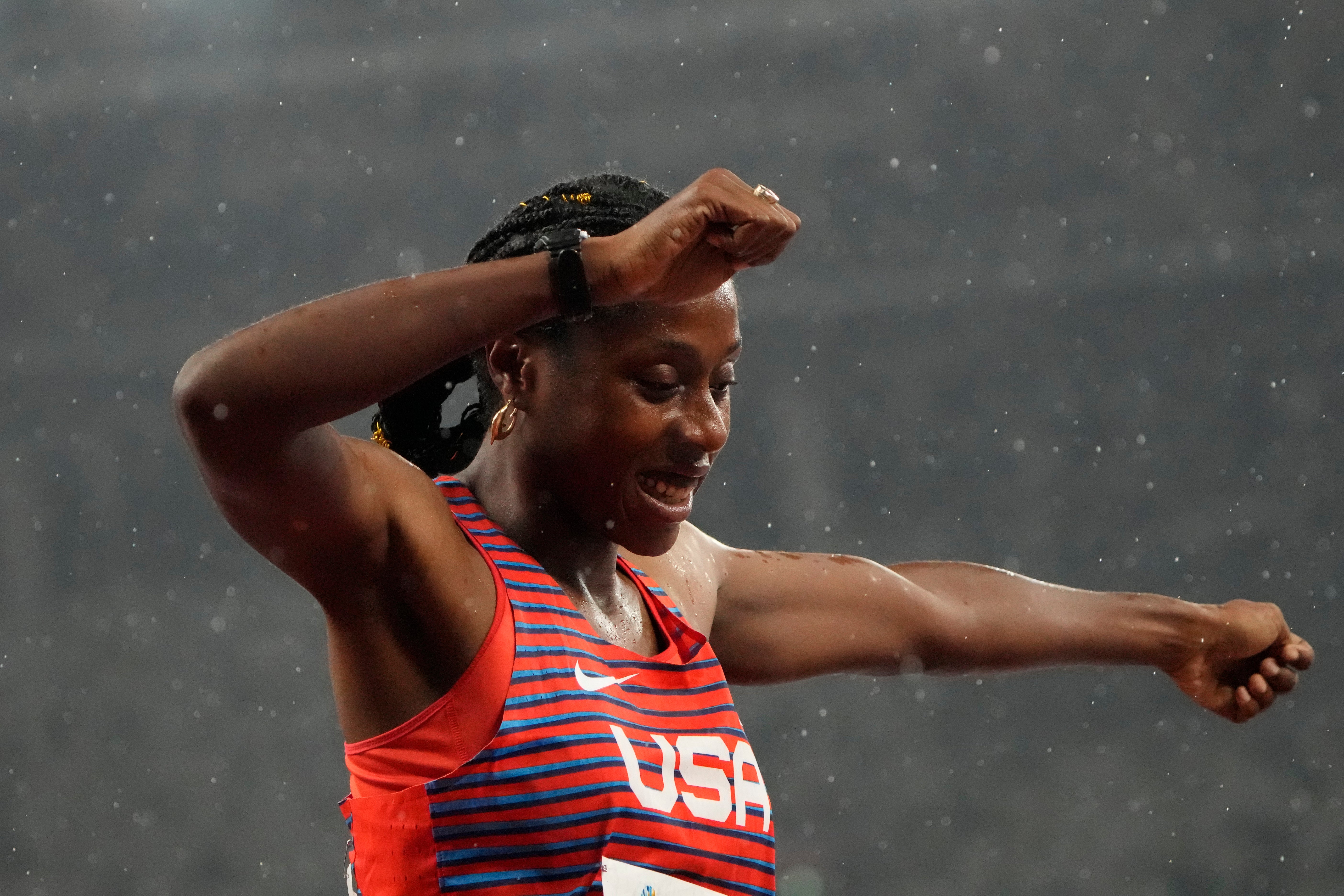 Breanna Clark dances in the rain after winning the women’s 400m T20 final (Eugene Hoshiko/AP)