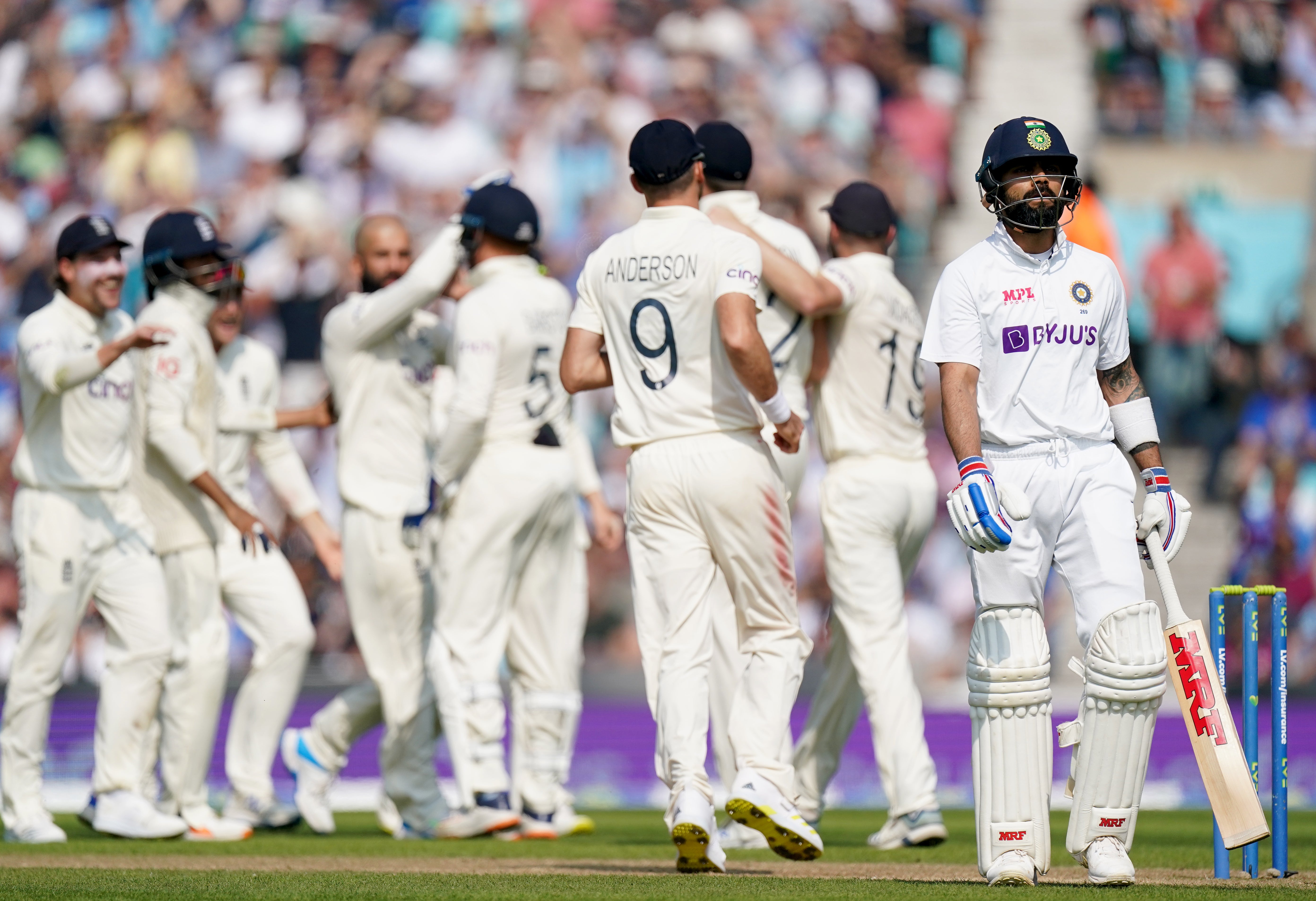 England celebrate taking the wicket of Virat Kohli, right (Adam Davy/PA)