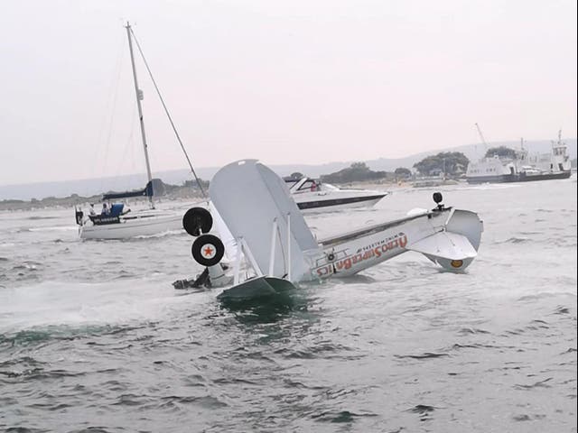 <p>Eyewitnesses saw the  two-seat biplane crash down in Poole Harbour, near Bournemouth, on Saturday afternoon</p>