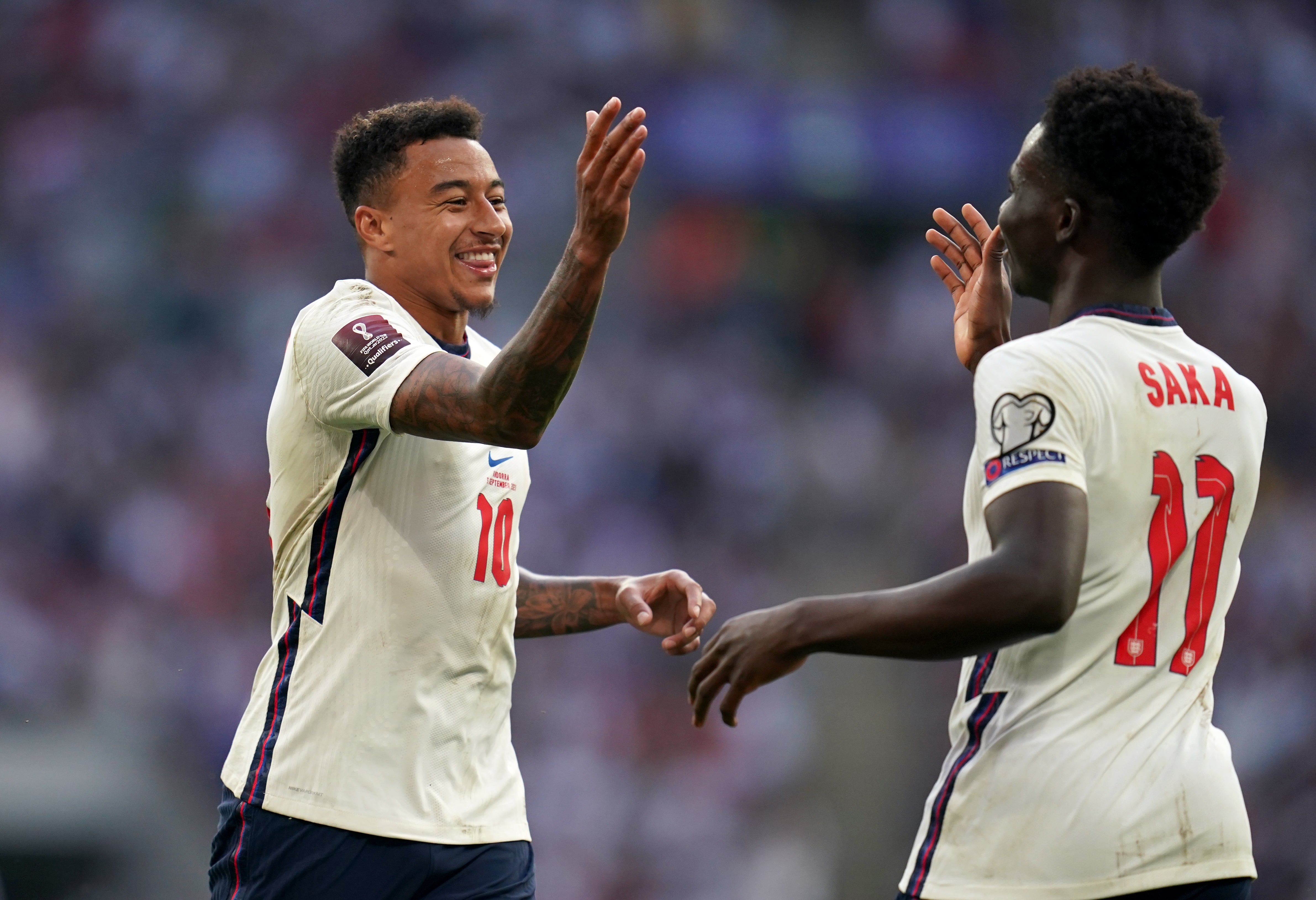 Jesse Lingard, left, celebrates with Saka, right, after scoring one of his two goals against Andorra (Nick Potts/PA)