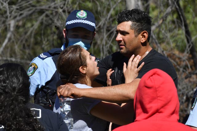 <p>Anthony Elfalak, right, and his wife, Kelly, embrace after hearing their son AJ was found alive on Monday morning </p>
