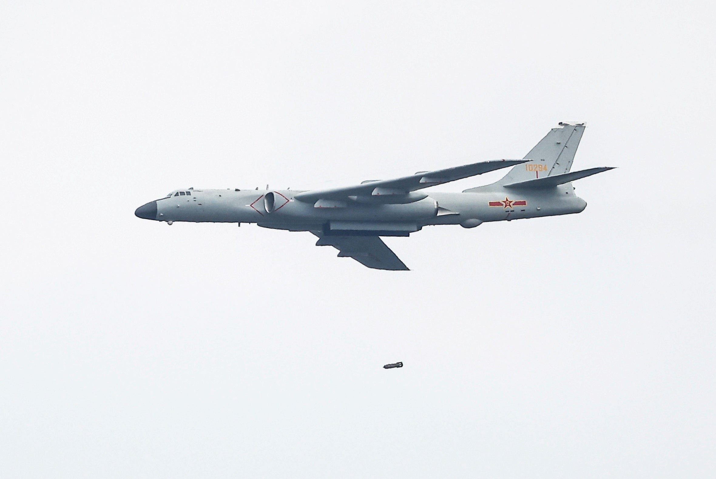 Representative: A Chinese Xian H-6 jet bomber drops a bomb during the Aviadarts competition, as part of the International Army Games 2021, at the Dubrovichi range outside Ryazan, Russia on 27 August 2021