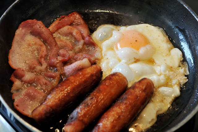 Egg, sausages and bacon being fried in a frying pan (Nick Ansell/PA)