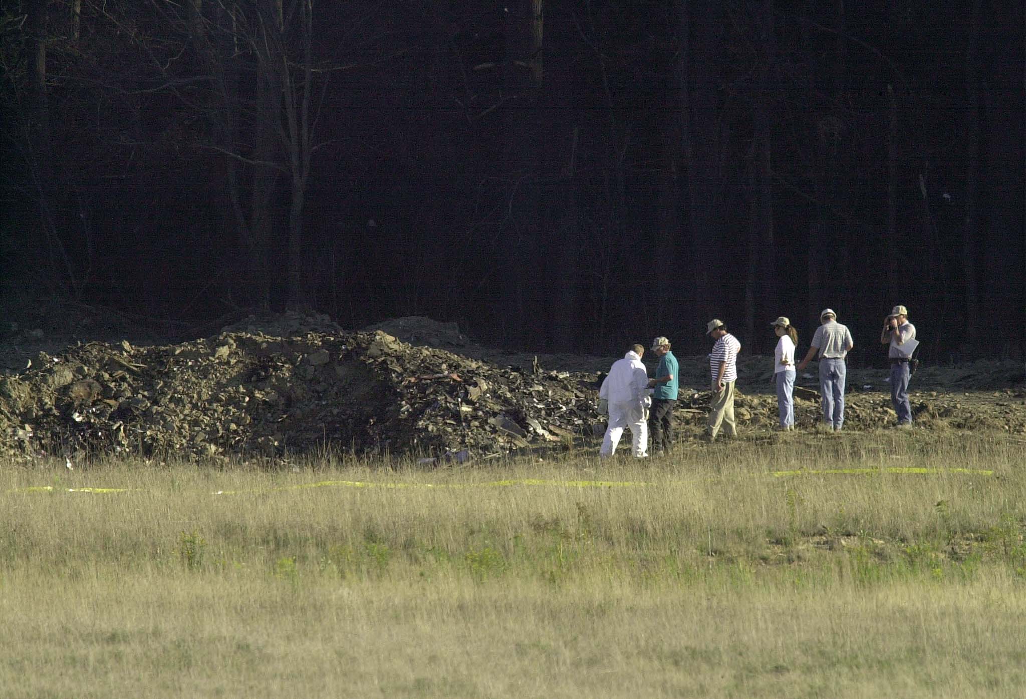Officials examine the wreckage of United Airlines Flight 93 in Shanksville, Pennsylvania