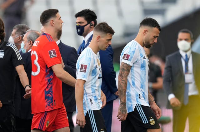 Argentina’s Giovani Lo Celso (centre) walks off the pitch with Nicolas Otamendi (right) and goalkeeper Emiliano Martinez (Andre Penner/AP).