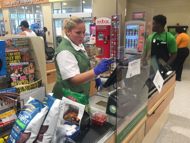 <p>A Publix supermarket in Florida with Covid protections for staff</p>