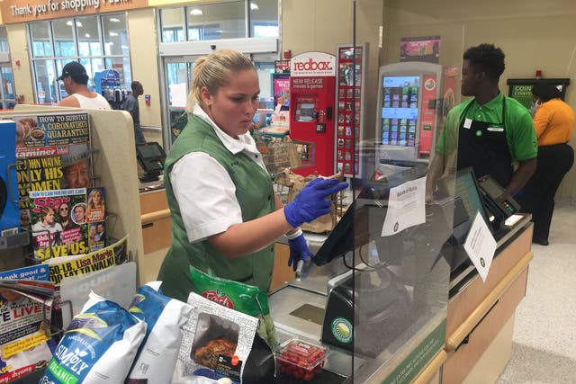 <p>A Publix supermarket in Florida with Covid protections for staff</p>