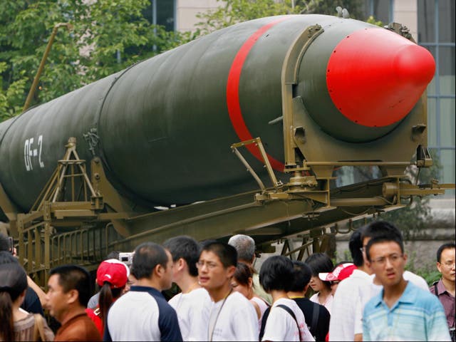 <p>Visitors in Beijing walk past China’s second ever nuclear missile on display at a museum</p>