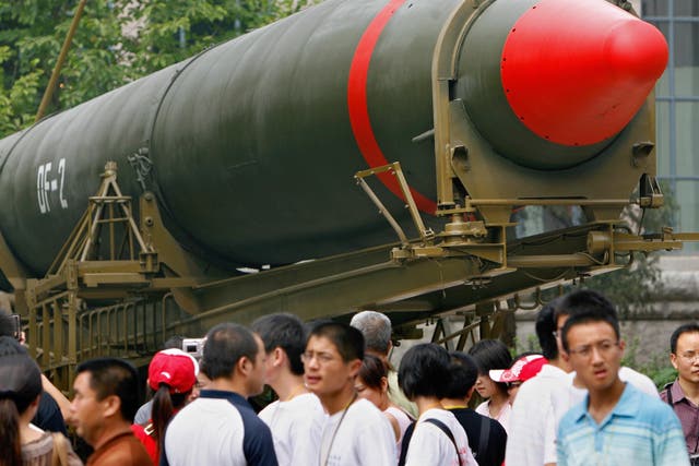 <p>Visitors in Beijing walk past China’s second ever nuclear missile on display at a museum</p>