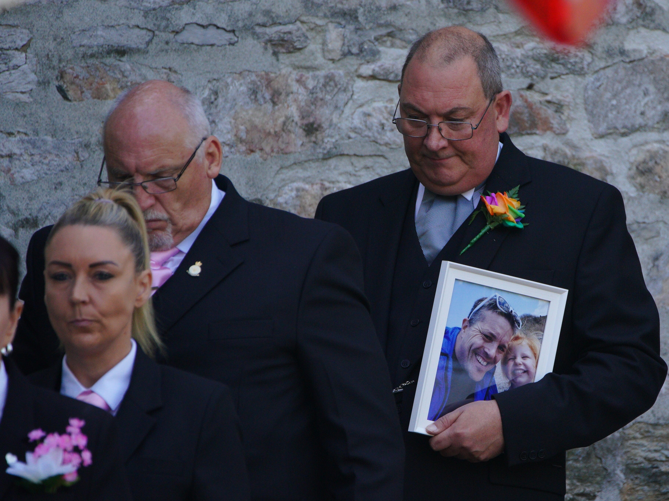 Mourners carrying a photograph of Lee and Sophie Martyn leave the church after the pair’s funeral in Plymouth