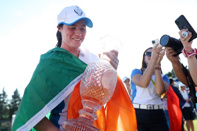 <p>Leona Maguire celebrates with the Solheim Cup</p>