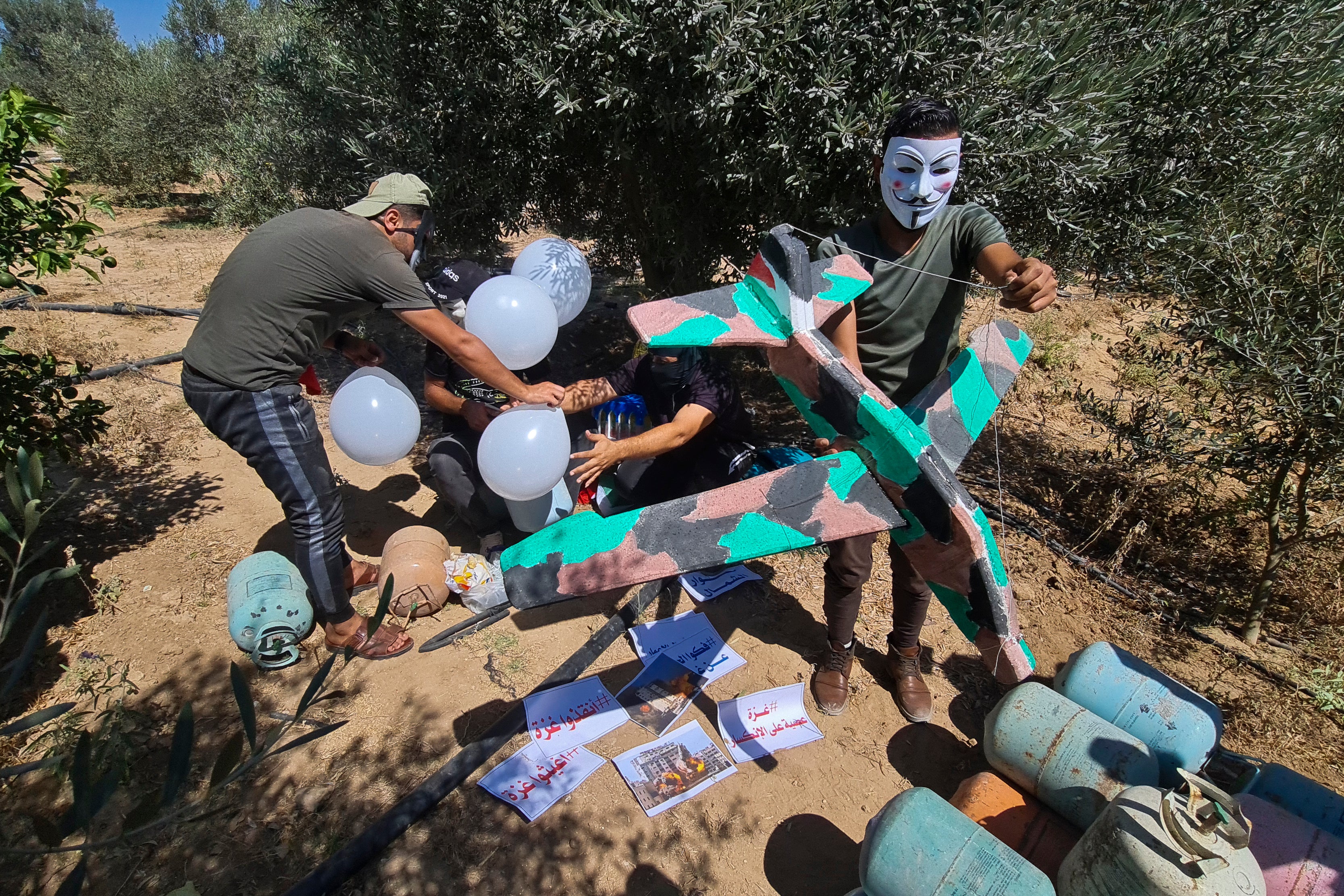 Masked Hamas-affiliated operatives launched balloons towards Israel, next to the eastern border of Gaza Strip, prompting Israel to retaliate with air