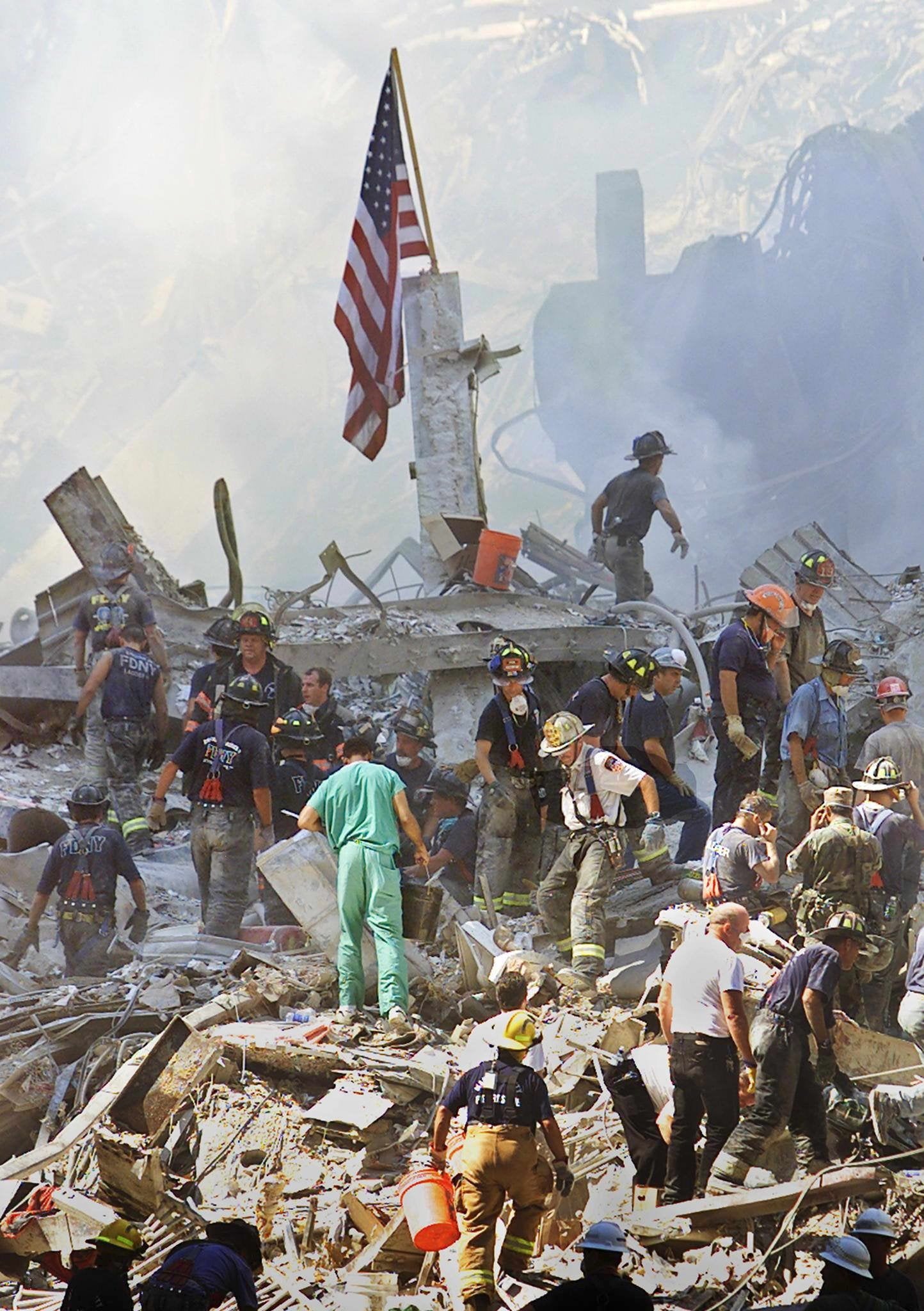 An American flag is posted in the rubble of the World Trade Centre as firemen and rescue workers clear the debris
