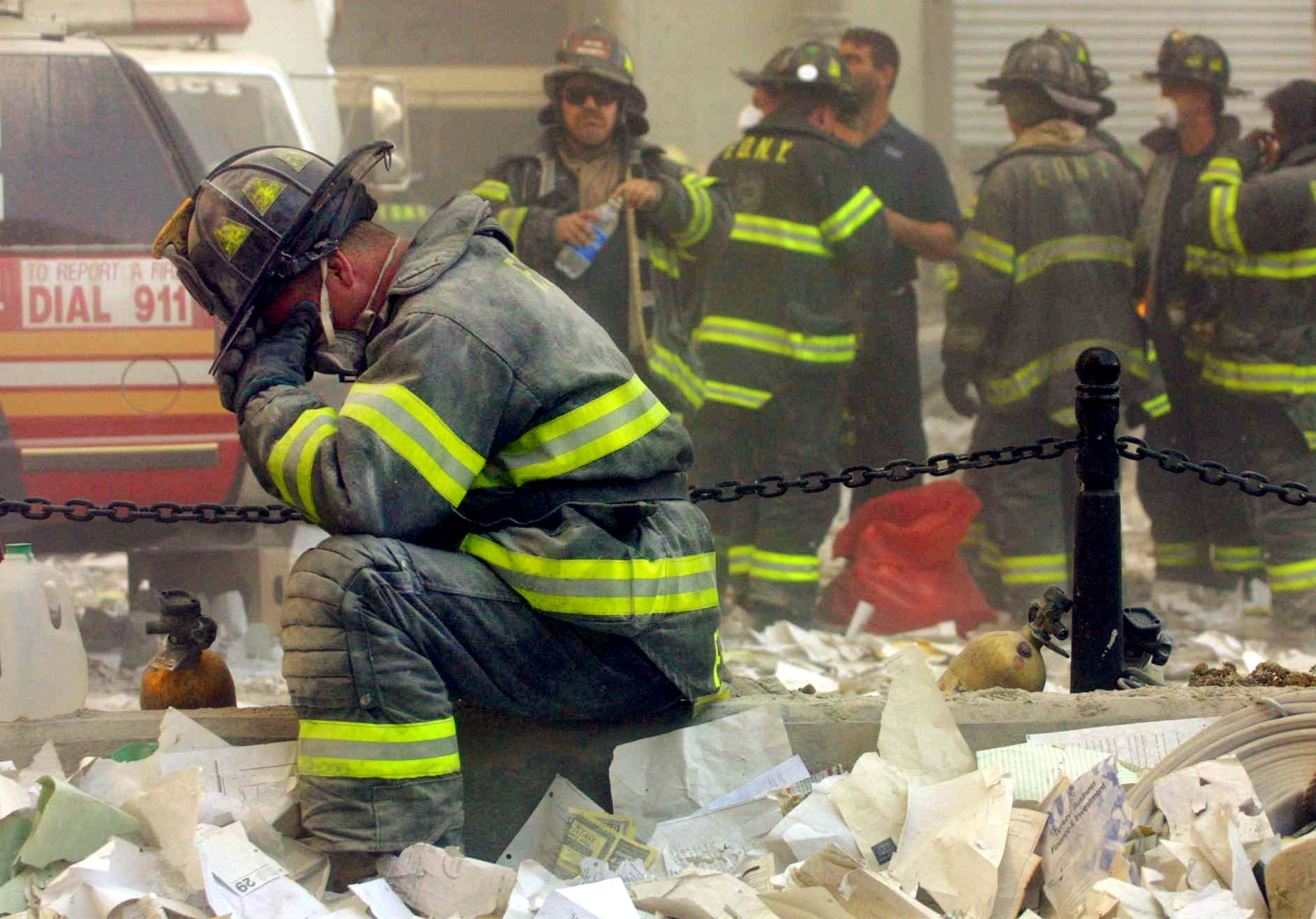 Firefighter Gerard McGibbon, of Engine 283 in Brownsville, Brooklyn, prays after the buildings collapsed