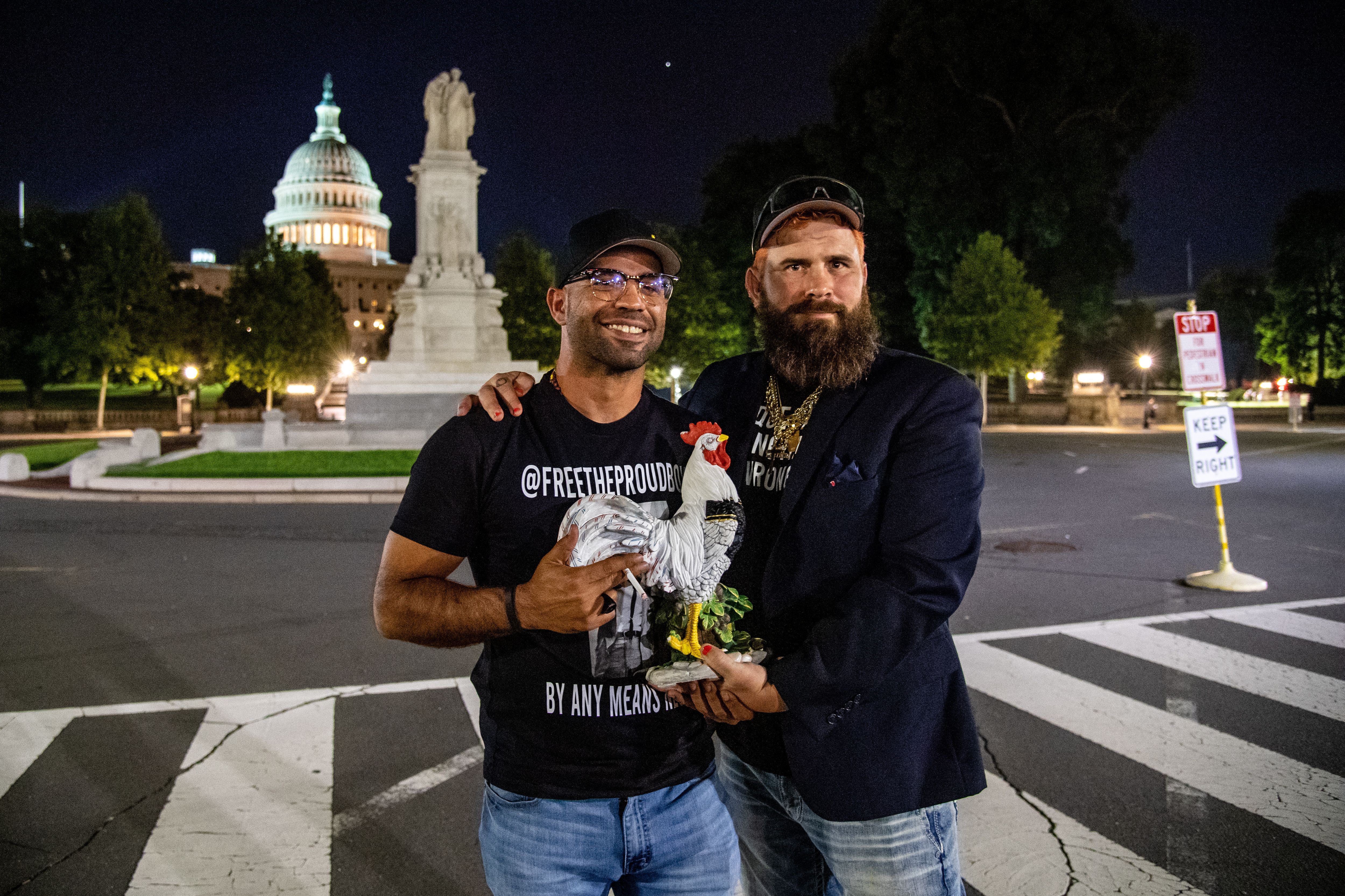 Proud Boys chairman Enrique Tarrio stands in front of the US Capitol holding a model rooster