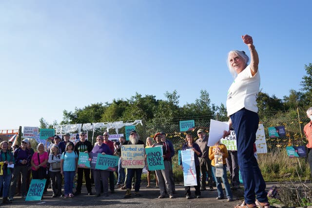 <p>Protesters gather outside the site of the proposed Cumbria coal mine on 7 September, 2021. </p>
