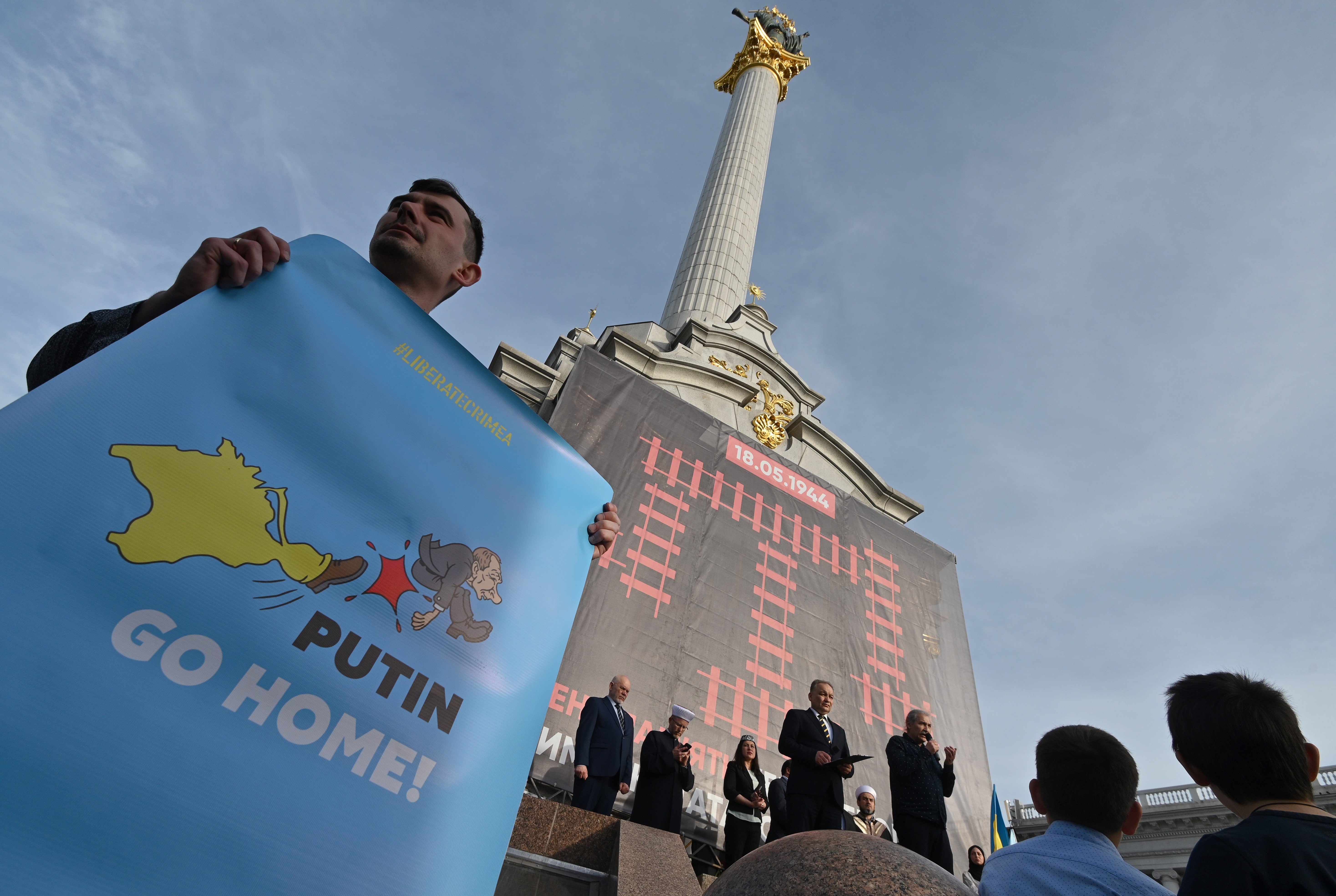 A man holds and anti-Russian placard on Kyiv’s Independence Square in 2019 during a memorial for the 75th anniversary of the deportation of the Crimean population by the Soviet Union