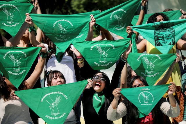 <p>Women hold green handkerchiefs during a protest in support of legal and safe abortion in Mexico City</p>