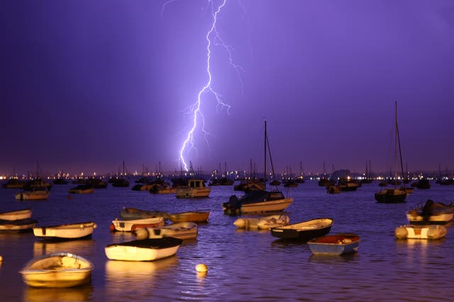 <p>Lightning strikes over Poole Harbour during a thunderstorm</p>