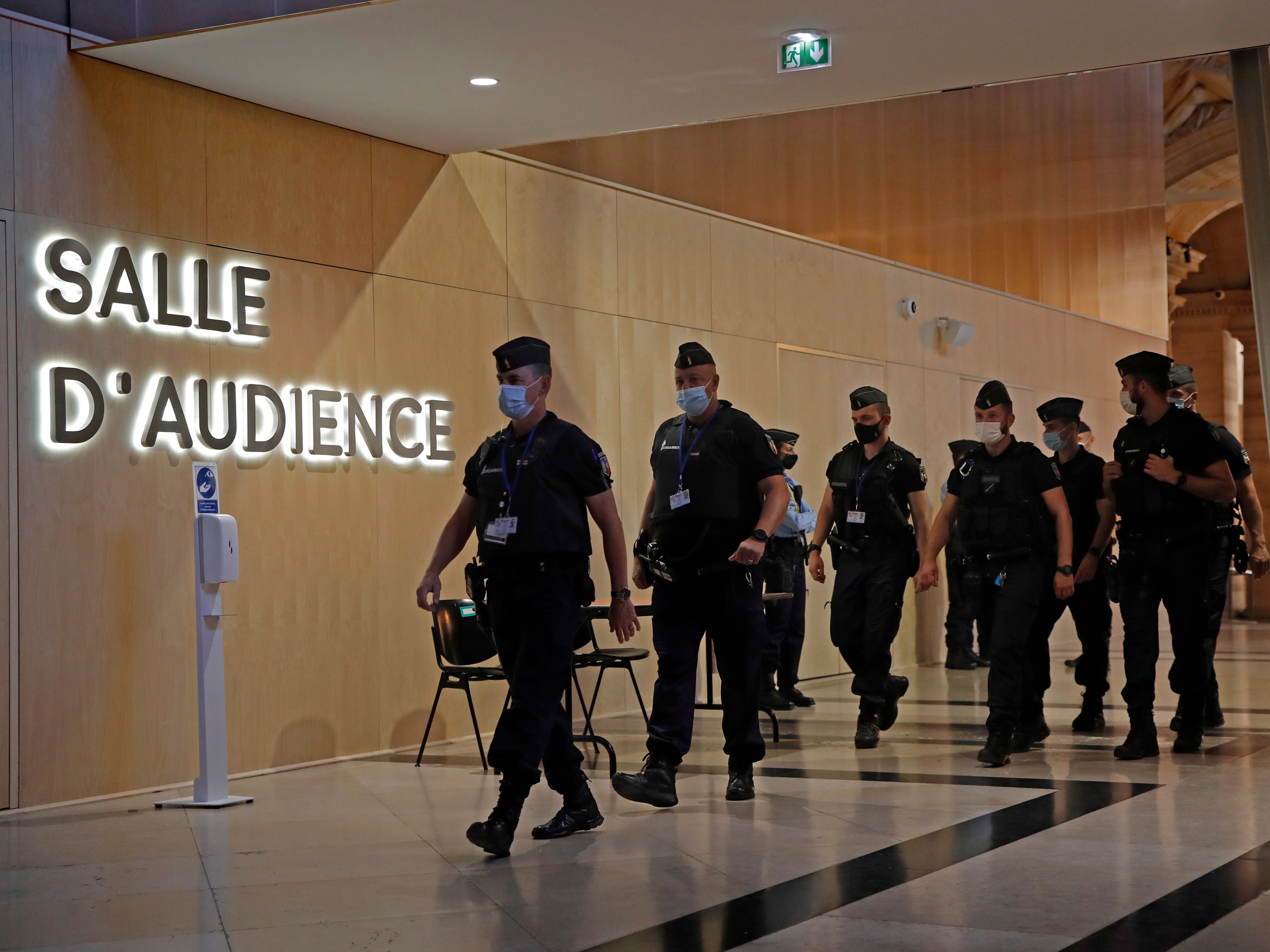 Police officers arrive at the courthouse in Paris