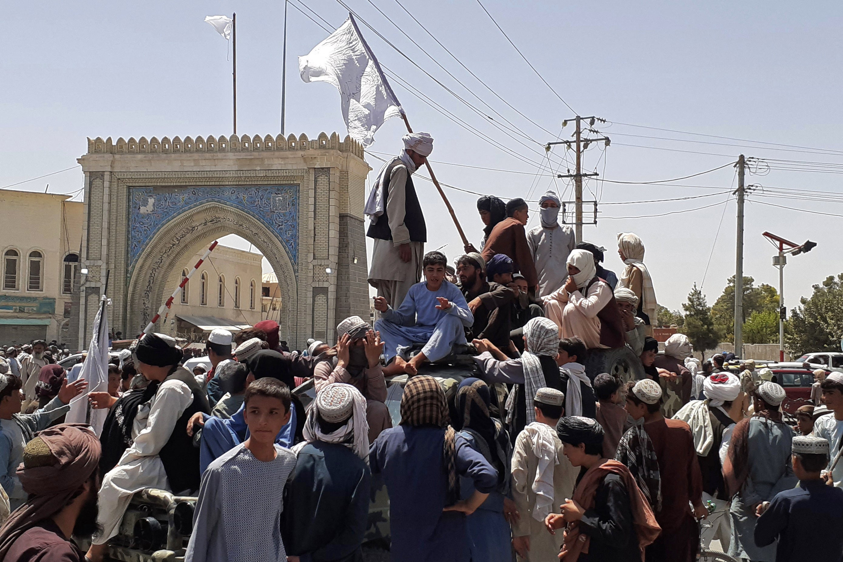 File: Taliban fighters stand on a vehicle along the roadside in Kandahar on 13 August 2021