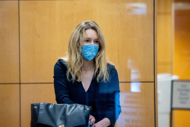 <p>Theranos founder Elizabeth Holmes collects her belongings after going through security at the Robert F. Peckham Federal Building with her defense team on August 31, 2021 in San Jose, California</p>