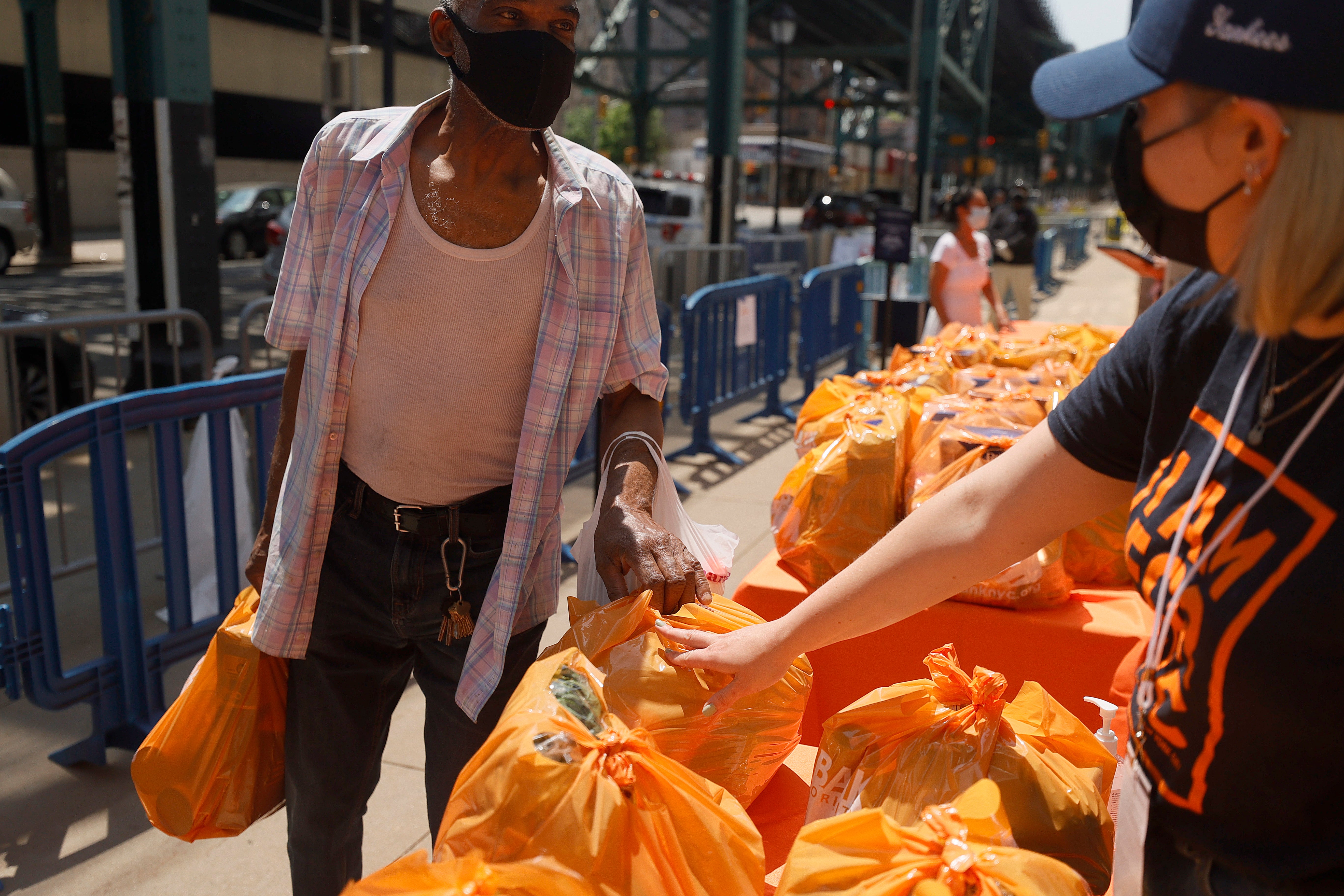 <p> Local residents receive food items as Food Bank For New York City teams up with the New York Yankees to kick-off monthly food distribution for New Yorkers in need at Yankee Stadium on May 20, 2021 in New York City. </p>