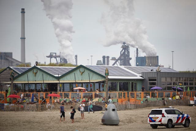 <p>People enjoy the beach near the Tata Steel plant in Velsen-Noord</p>