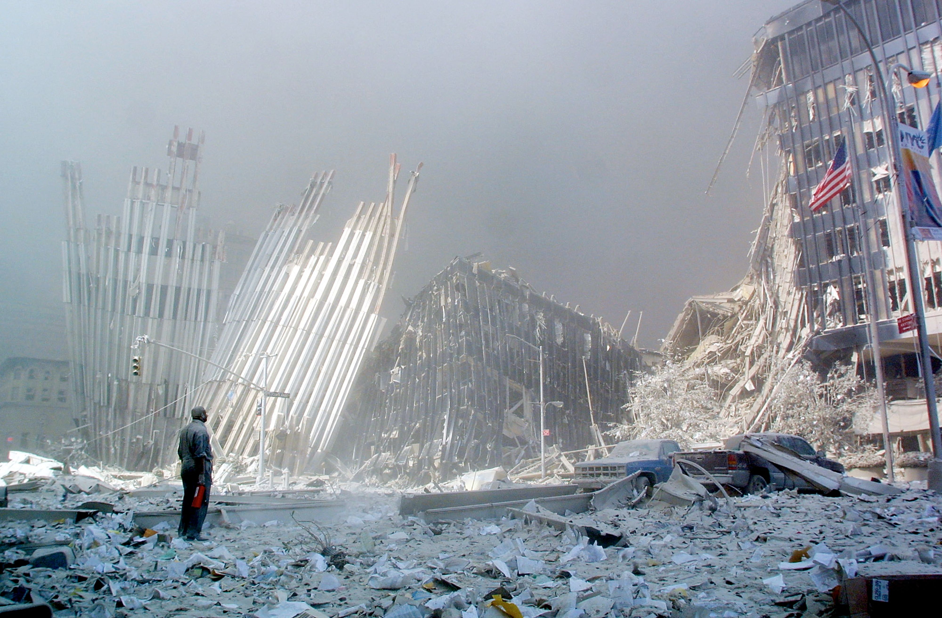 <p>A  man stands in the rubble and calls out asking if anyone needs help on 9/11</p>