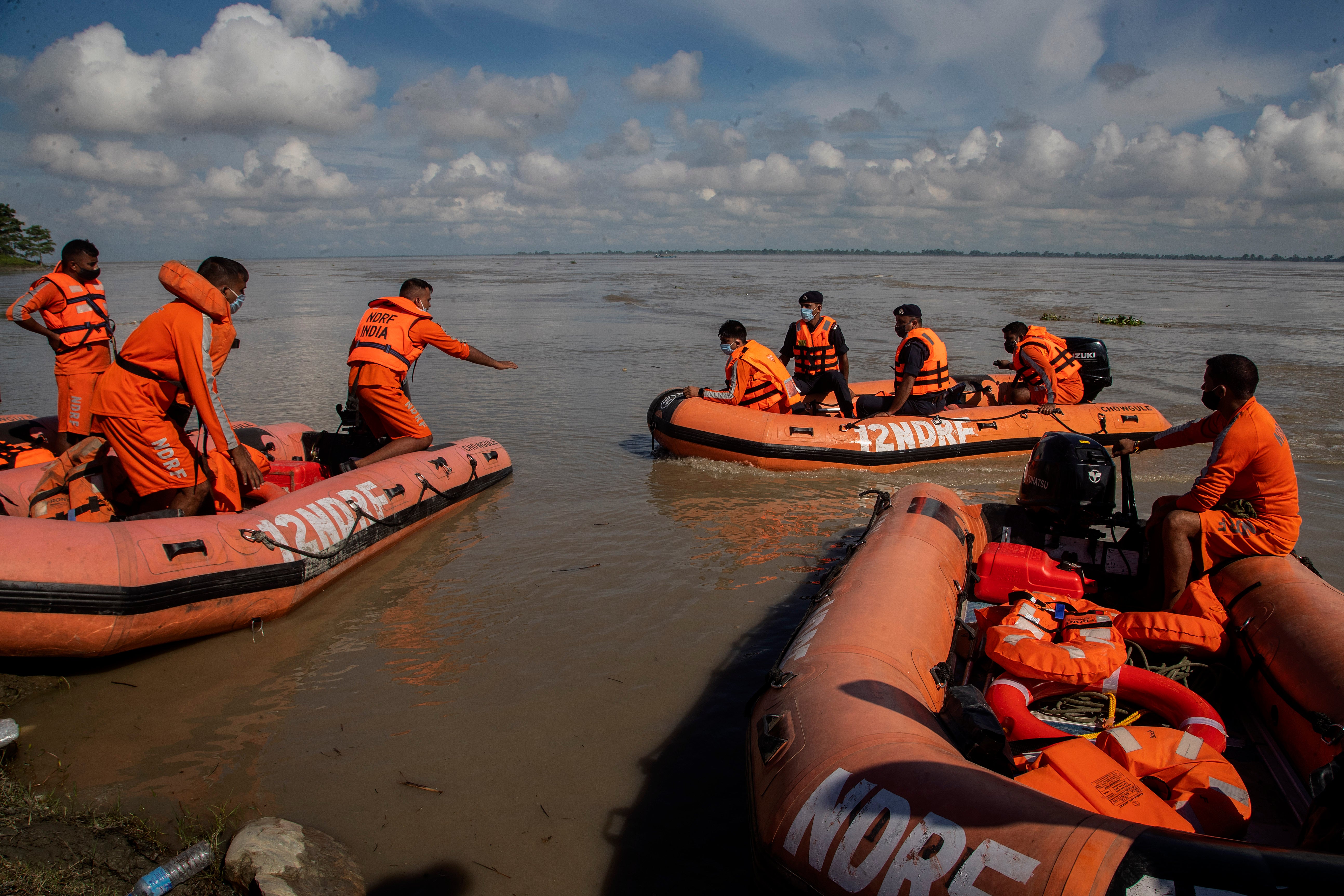 <p>National Disaster Response Force personnel search for missing people after two passenger ferries collided Wednesday in the river Brahmaputra, near Nimati Ghat, in Jorhat, about 350 kilometres (220 miles) from Gauhati, Assam state, India, Thursday, 9 September 2021</p>