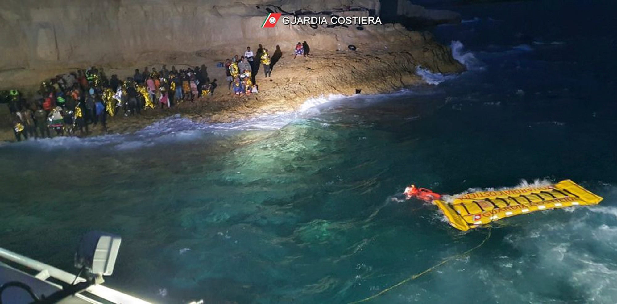 The migrants were spotted after reports of a big group huddling at the base of a cliff