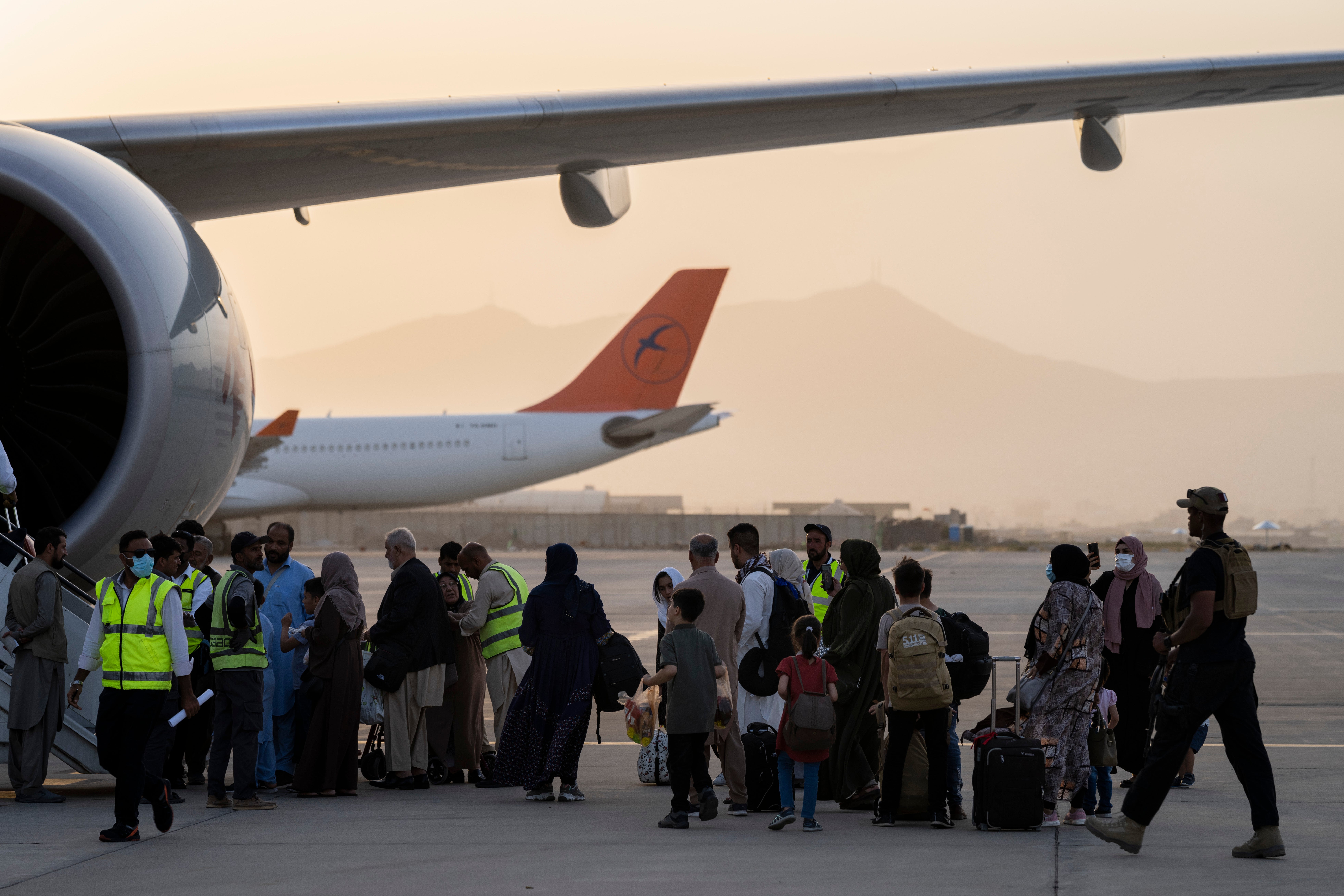 Foreigners board a Qatar Airways aircraft at the airport in Kabul, Afghanistan