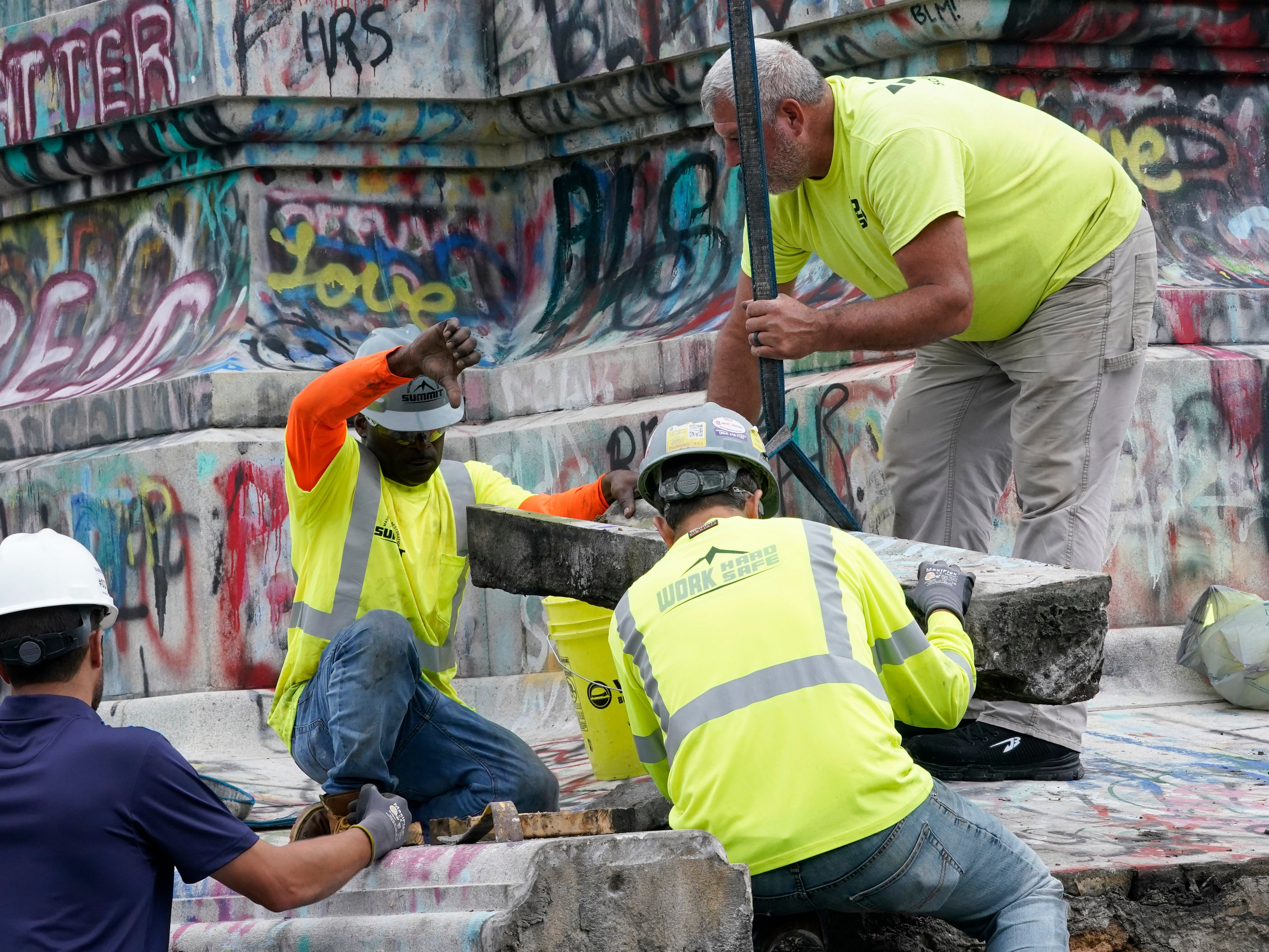 <p>Crews dismantle the corner of the pedestal of the Robert E. Lee statue as they attempt to locate a time capsule thought to be buried in the base on Monument Avenue in Richmond, Va., Thursday, Sept. 9, 2021</p>