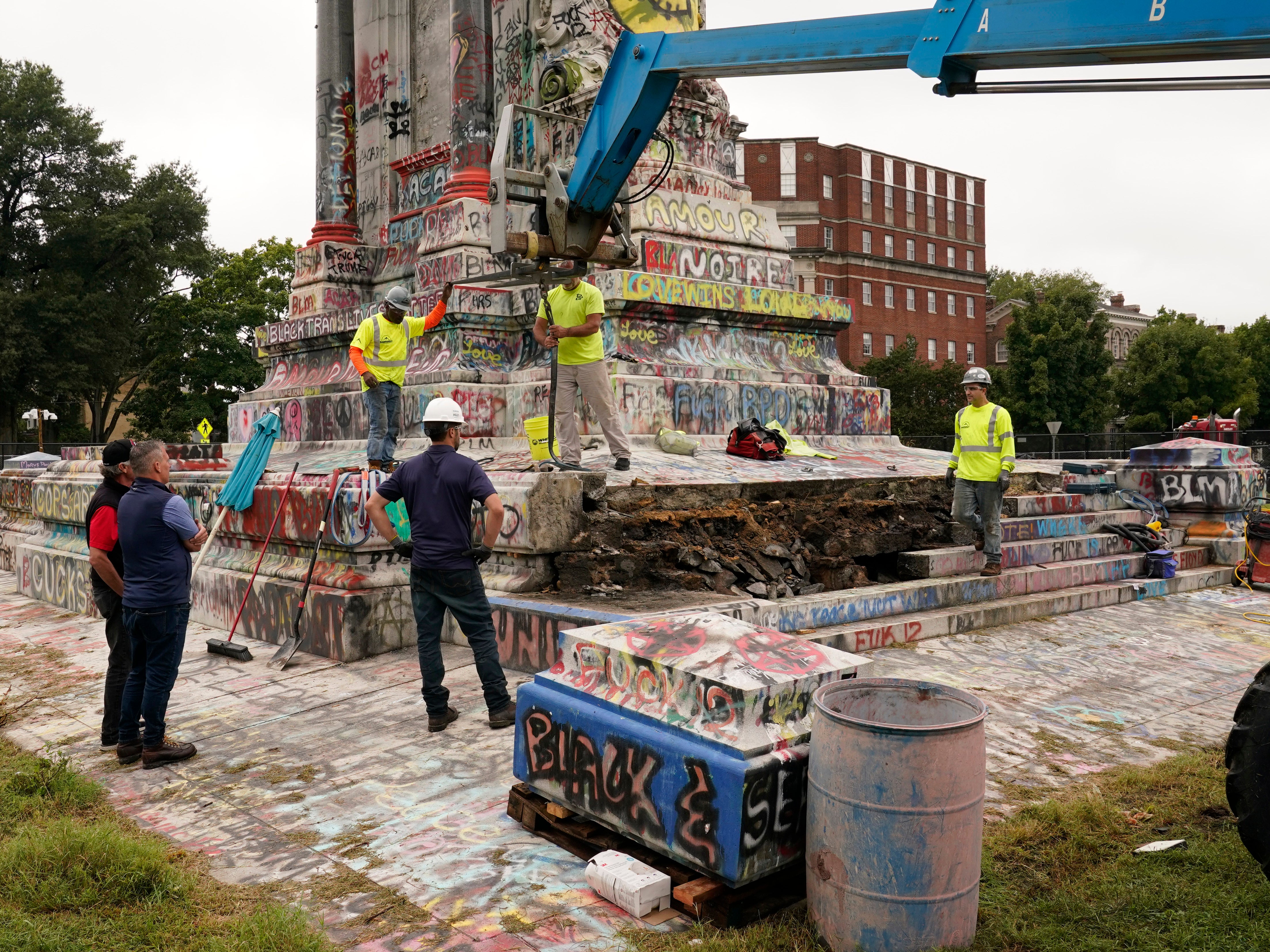 Crews dismantle the corner of the pedestal of the Robert E. Lee statue as they attempt to locate a time capsule thought to be buried in the base on Monument Avenue in Richmond, Va., Thursday, Sept. 9, 2021