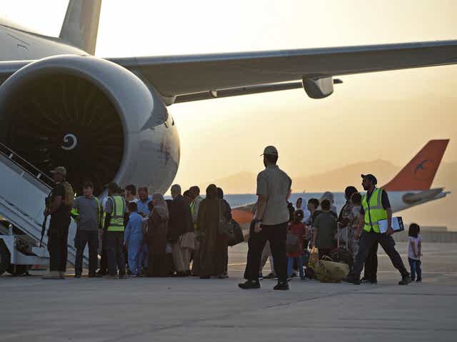 <p>Afghan evacuees board a flight in Qatar bound for the US on September 9 </p>