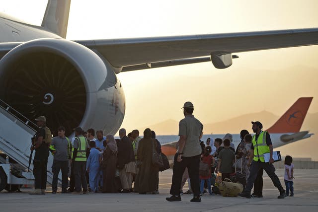 <p>Afghan evacuees board a flight in Qatar bound for the US on September 9 </p>