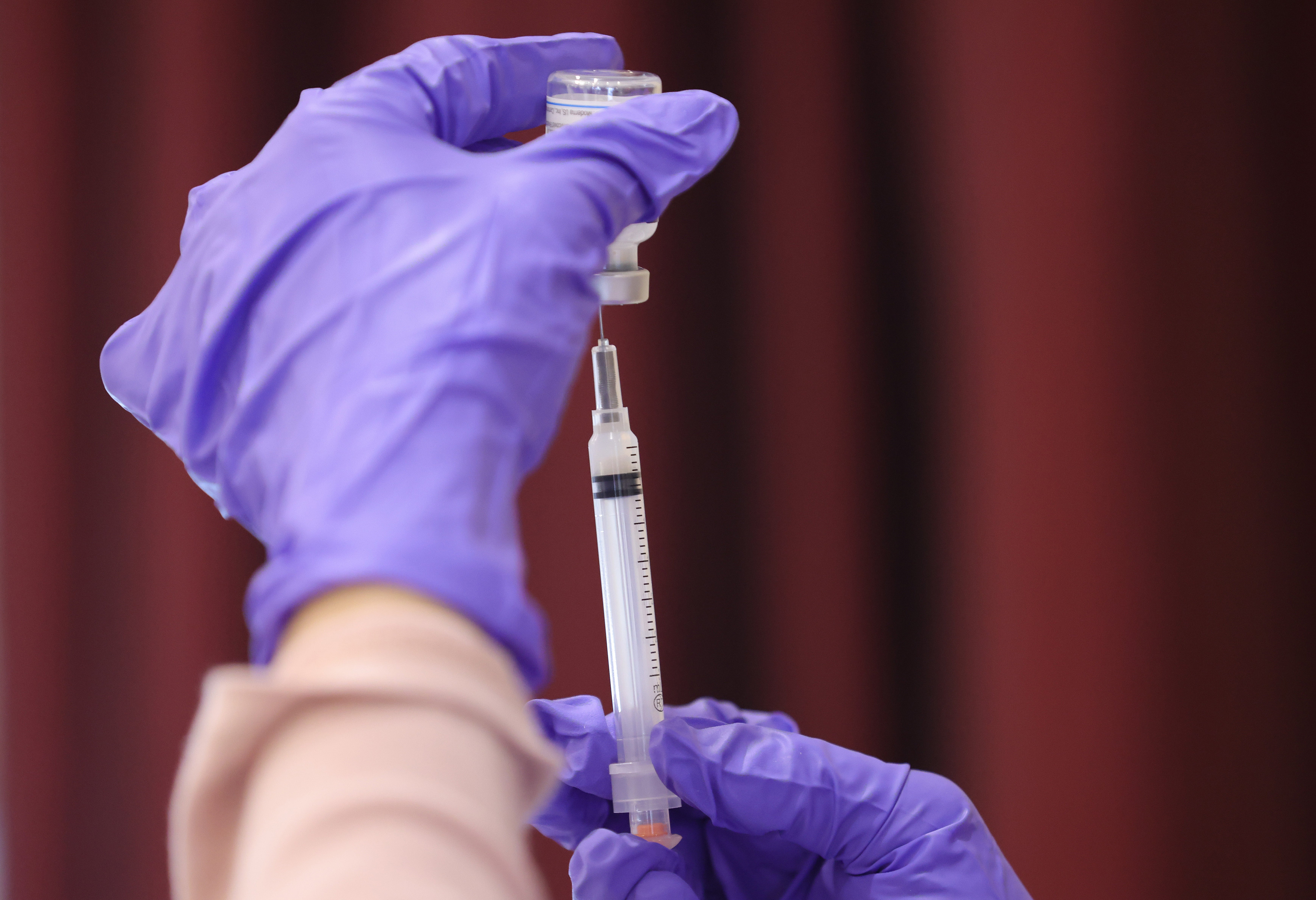 Nurses draw vaccine doses from a vial as Maryland residents receive their second dose of the Moderna coronavirus vaccine at the Cameron Grove Community Center on 25 March 2021 in Bowie, Maryland