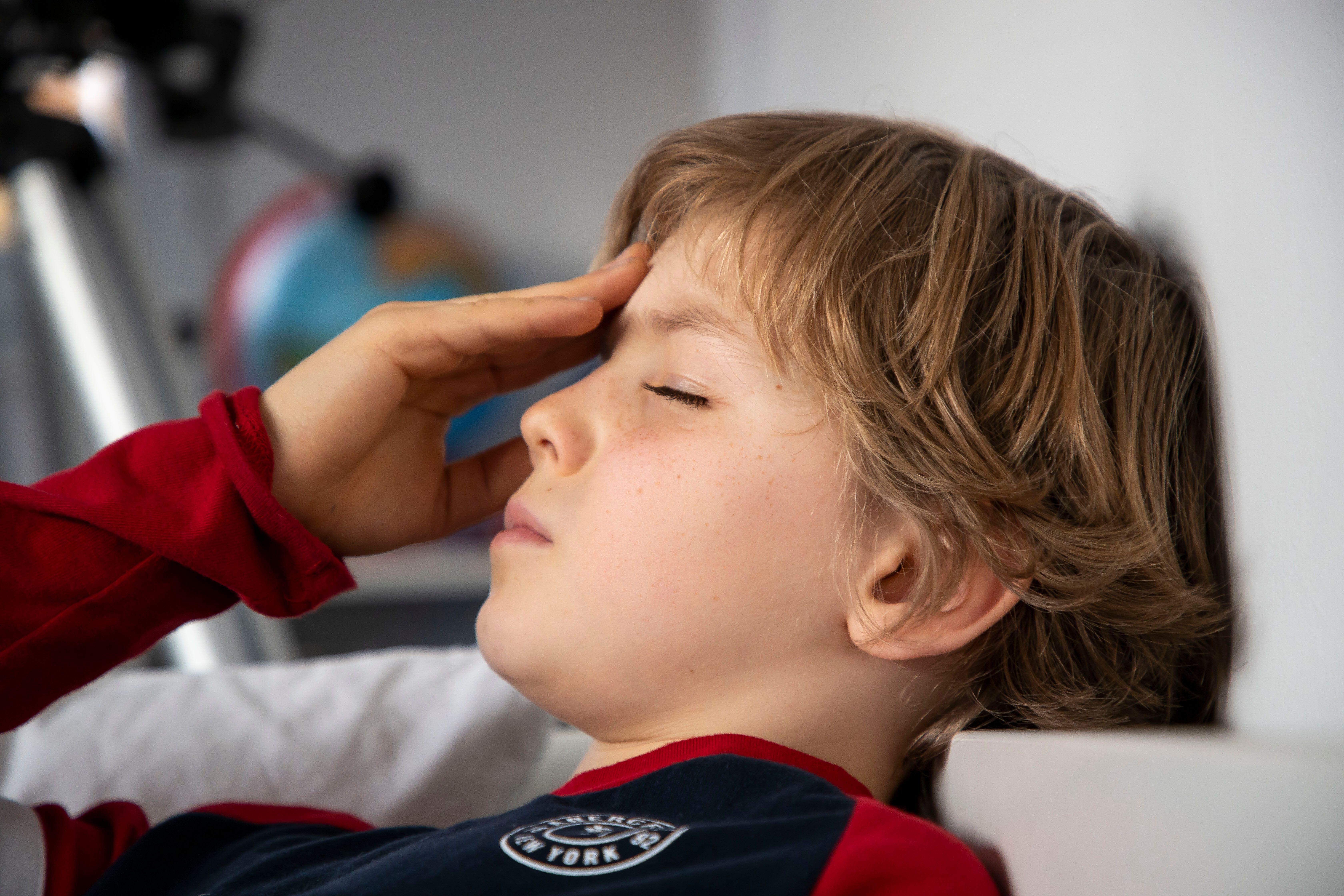 Child with a painful headache (Alamy/PA)