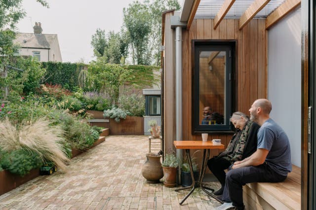 <p>Christine and Ben Magid surrounded by lovely old trees in the terraced garden</p>